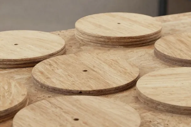 Discos lisos de madera sobre una mesa de trabajo.