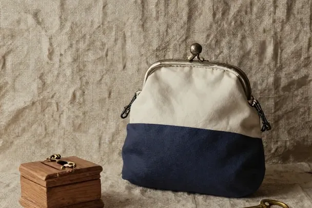 A plain wooden storage cabinet holds neatly separated linen resource pouches.