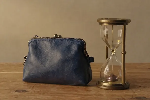 A plain hourglass sits beside a closed wallet and an unbranded headset.