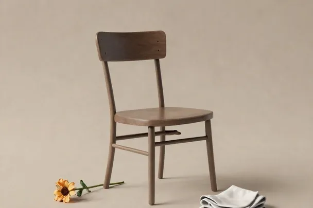 Silla vacía, flor marchita y pañuelo doblado evocan una despedida