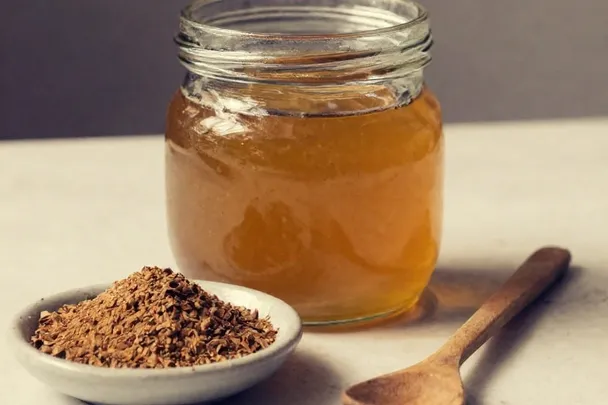 Canela molida y miel en recipientes sencillos sobre una mesa clara