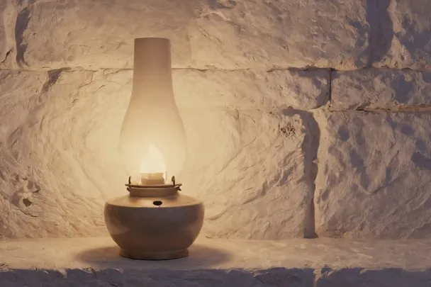 Lámpara de aceite ilumina suavemente una pared de piedra clara